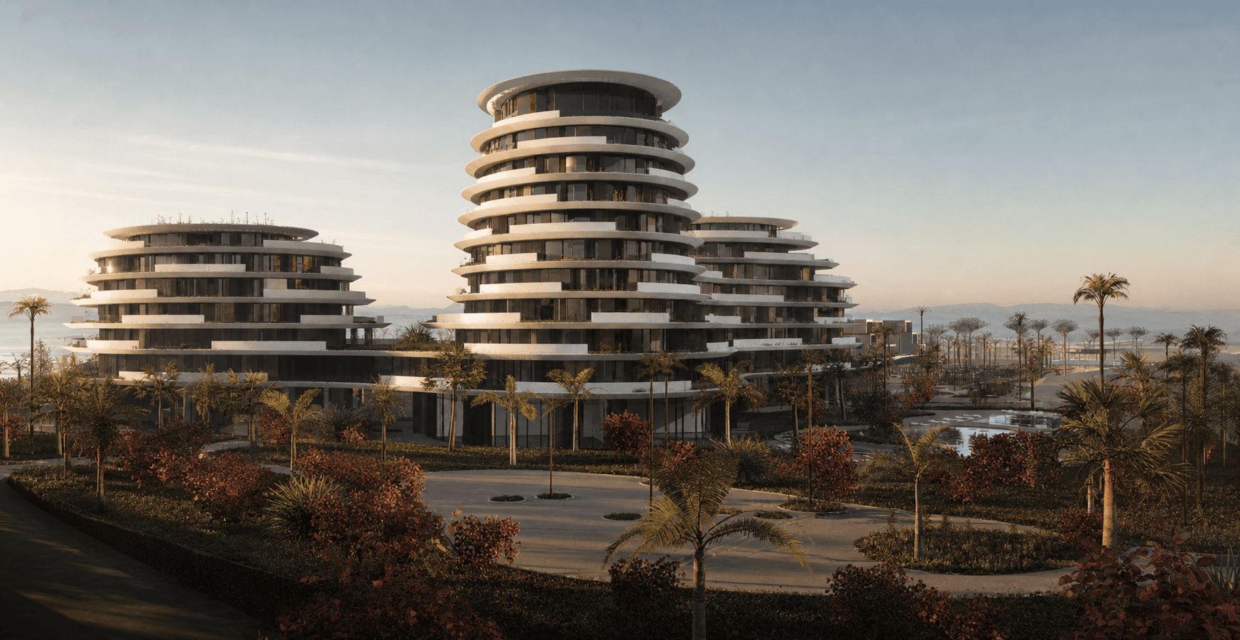 ULQIN residential development with three rounded white towers and Mediterranean landscaping